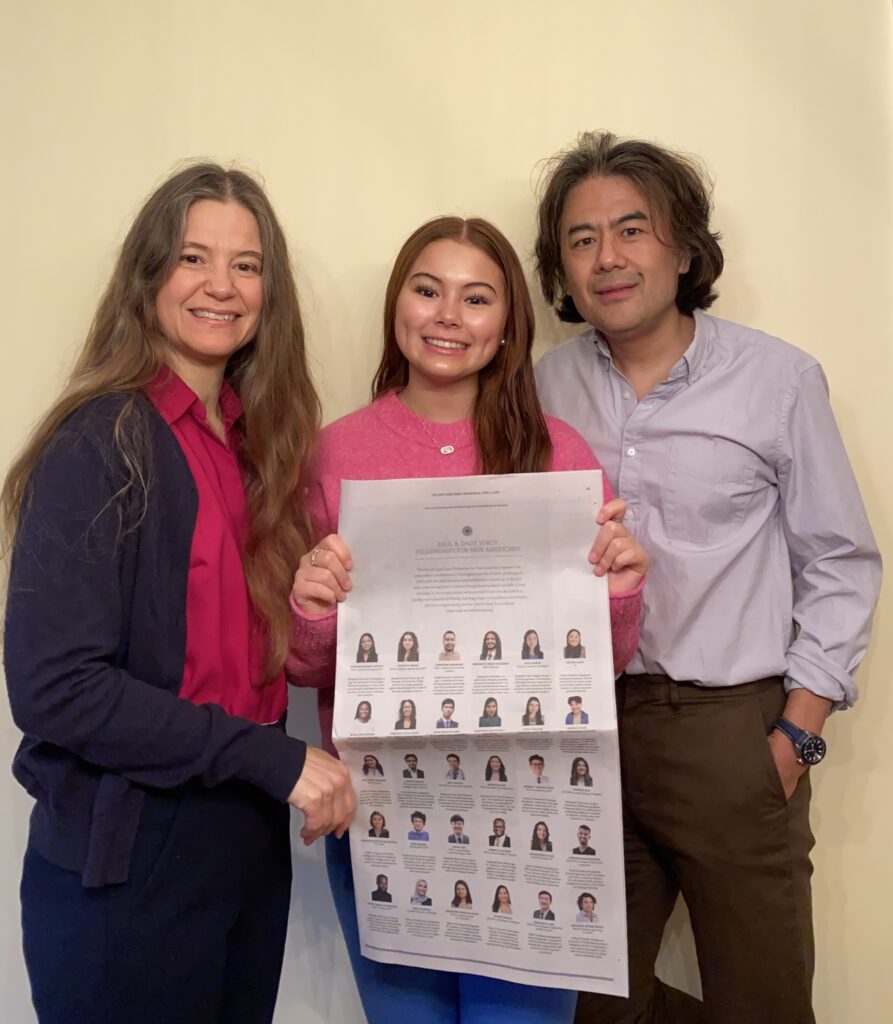 Photograph of three people, mom, sister and dad of fellow Russell Legate-Yang. They are standing in front of an off-white wall.