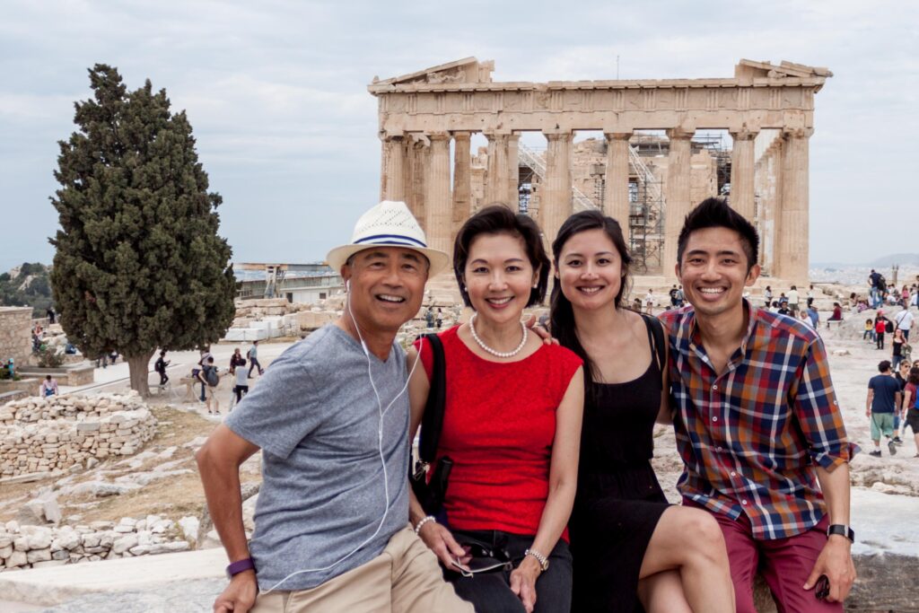 Photograph of a family posing on a sunny day.