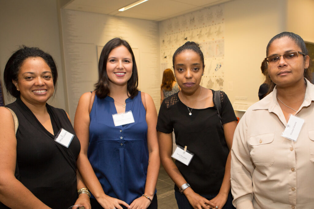 Photograph of four women posing for the camera. 