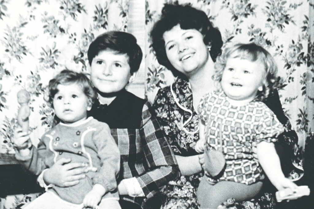 Black and white photograph from 1979 of a young woman and three children.