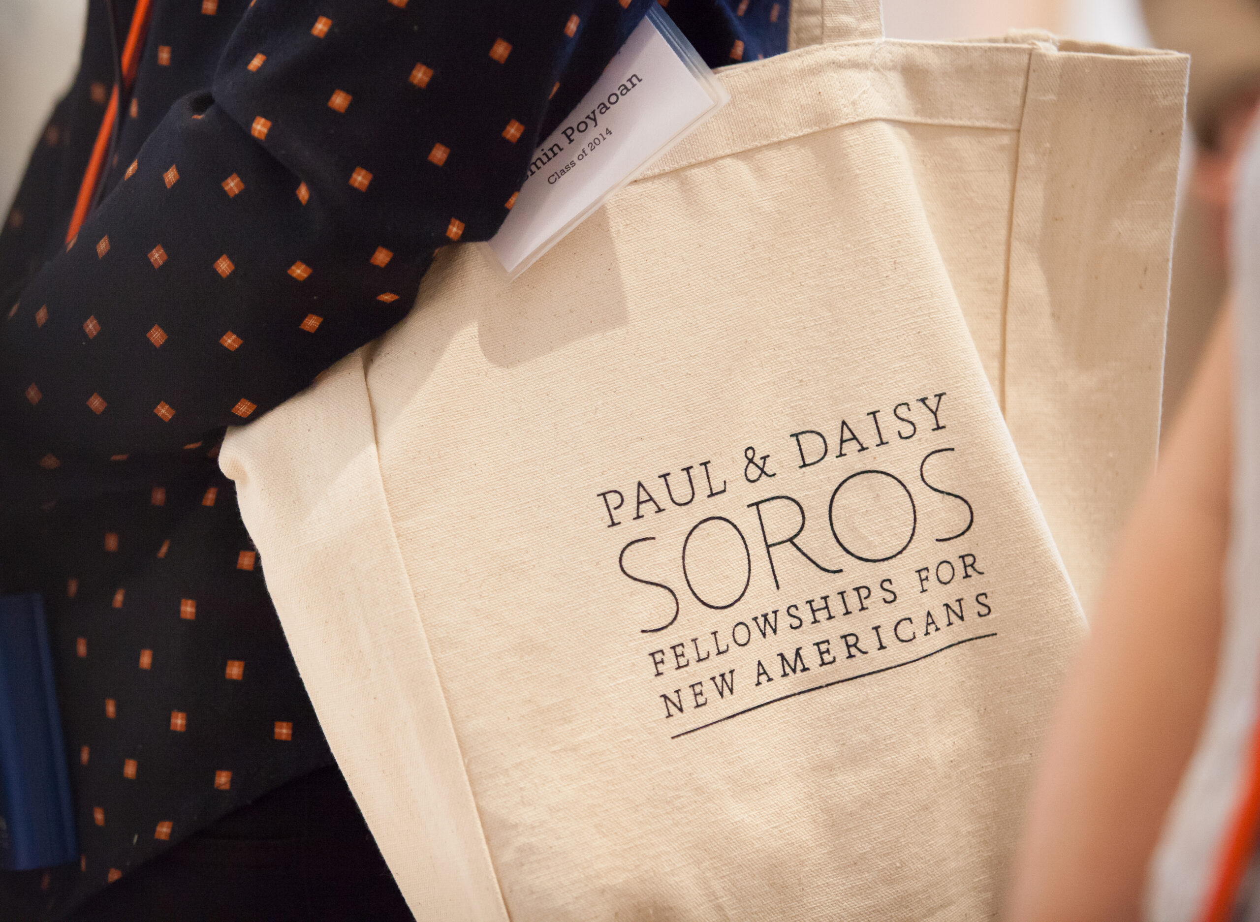 Close up of a canvas tote bag with the "Paul & Daisy Soros Fellowships for New Americans" logo printed in black