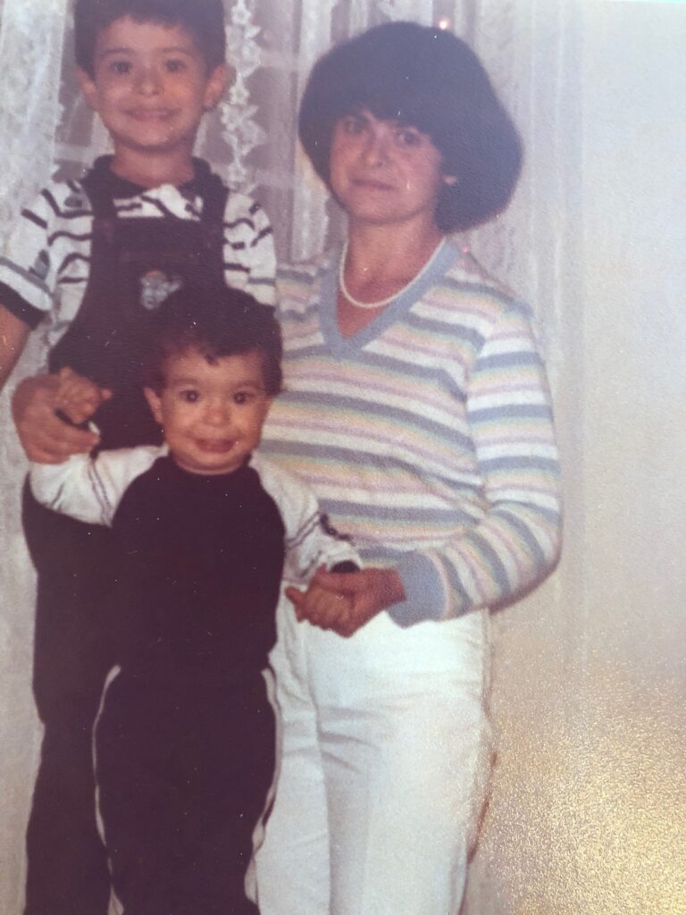 Old photograph of a woman in her 30s and two young boys.