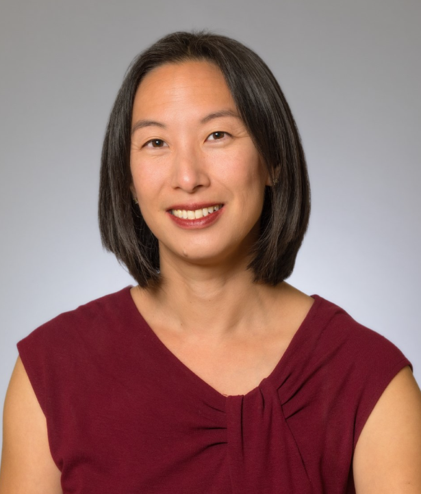 Headshot of a woman in her 40s with heritage from China and Taiwan, with light-medium skin tone and chin length layered straight black hair parted in the middle. She is wearing a red blouse with some rouching. She is smiling at the camera.